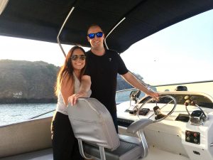 Torben and Alicia pose for a photo on their boat.